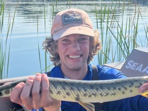Graduate student John Lawrence poses with a spotted gar.
